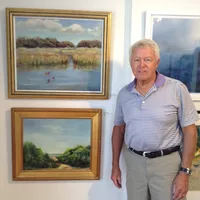 Don Van Dyke by two of his oils - photo by Robert Frazier
