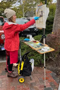 Meg Weeks painting in the rain - photo by Robert Frazier