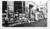 Maud Stumm hanging art at the 1931 SAS, corner of Federal & Broad Streets